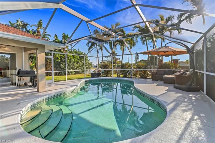 Pool with a lanai, area for grilling, a patio area, and an outdoor hangout area