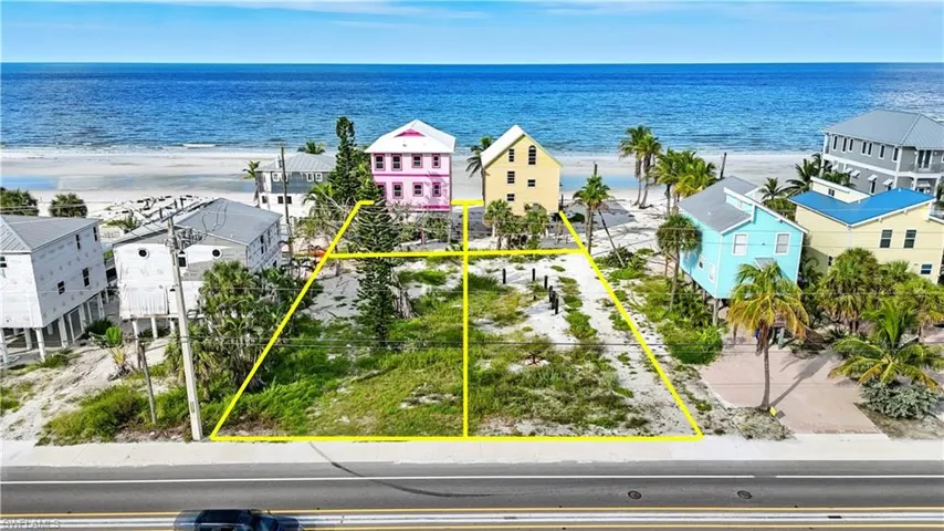 Aerial view of residential area featuring expansive coastline
