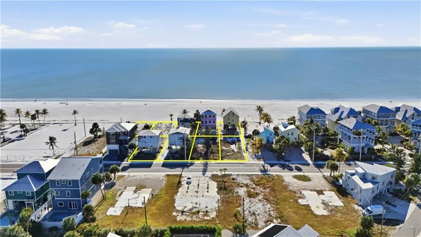 Aerial view of residential area with waterfront with a beach