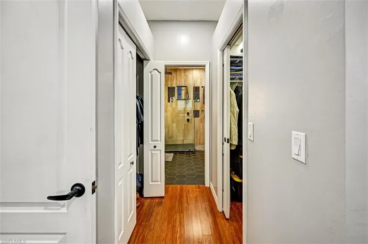 Hall with dark wood-style flooring