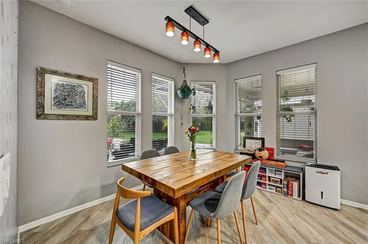 Dining space with baseboards and light wood-style flooring
