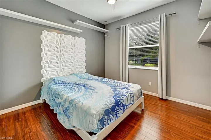 Bedroom featuring baseboards and hardwood / wood-style floors