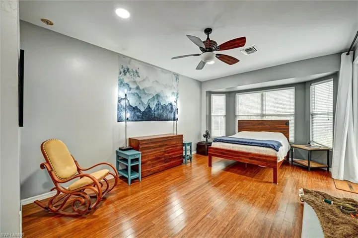 Bedroom featuring hardwood / wood-style flooring and ceiling fan