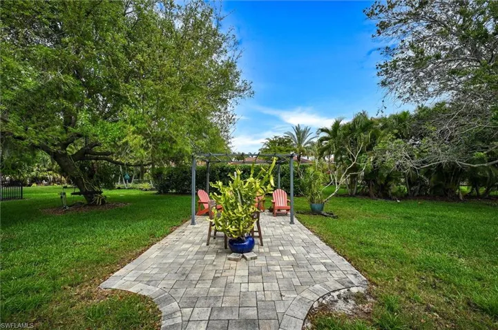 View of green lawn with a patio