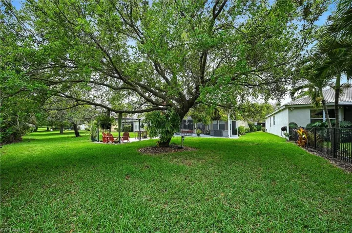View of green lawn featuring a sunroom