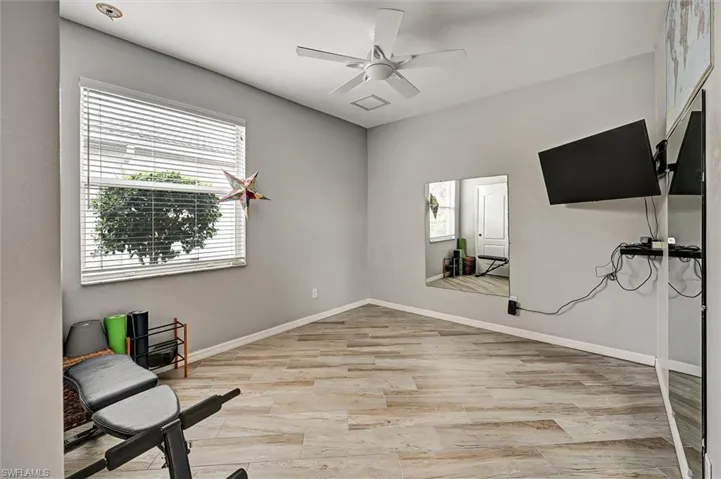 Living area featuring ceiling fan and light wood finished floors