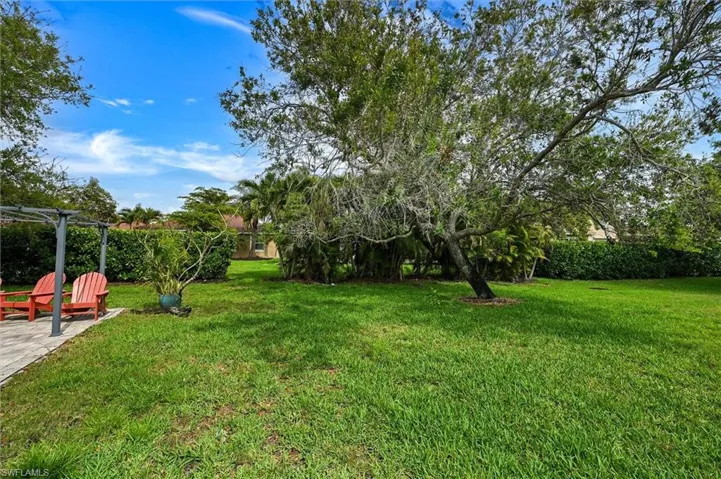 View of grassy yard featuring a patio area