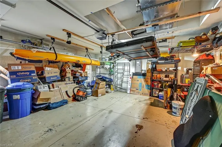 Garage featuring electric panel and a garage door opener