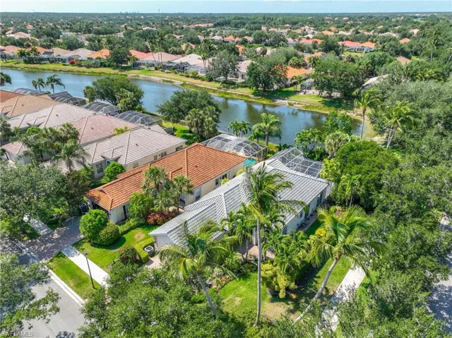 Aerial perspective of suburban area featuring a nearby body of water
