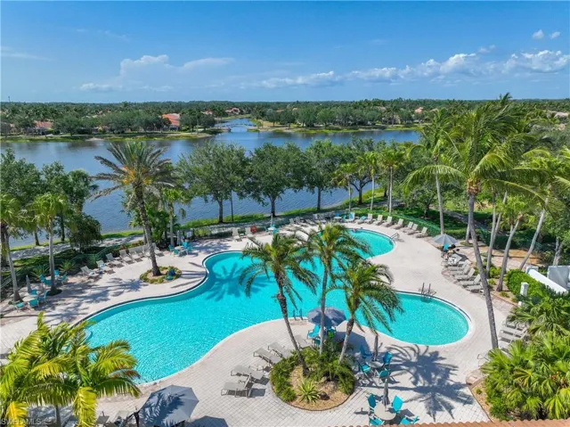 Community pool with a water view and a patio area
