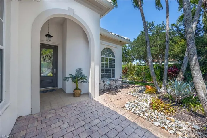 Property entrance featuring stucco siding and a patio area