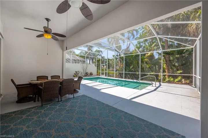 Swimming pool featuring a patio, ceiling fan, outdoor dining area