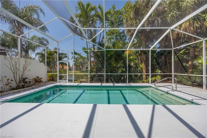 Swimming pool with a patio and  enclosure