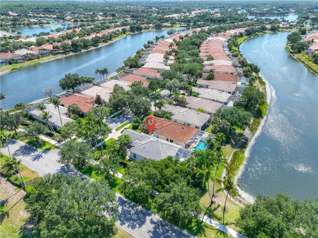Aerial perspective of suburban area featuring a large body of water