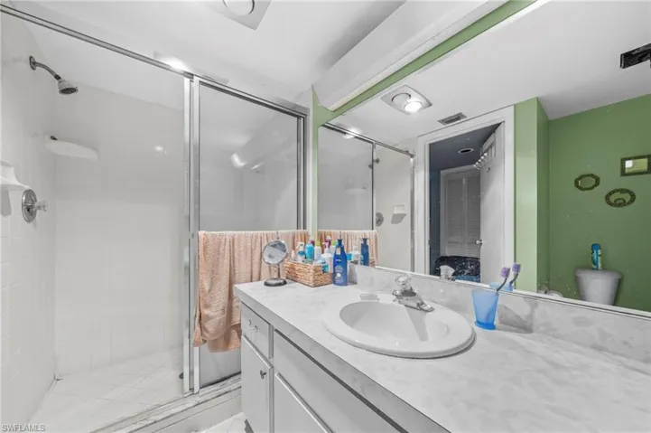 Bathroom featuring a stall shower and vanity