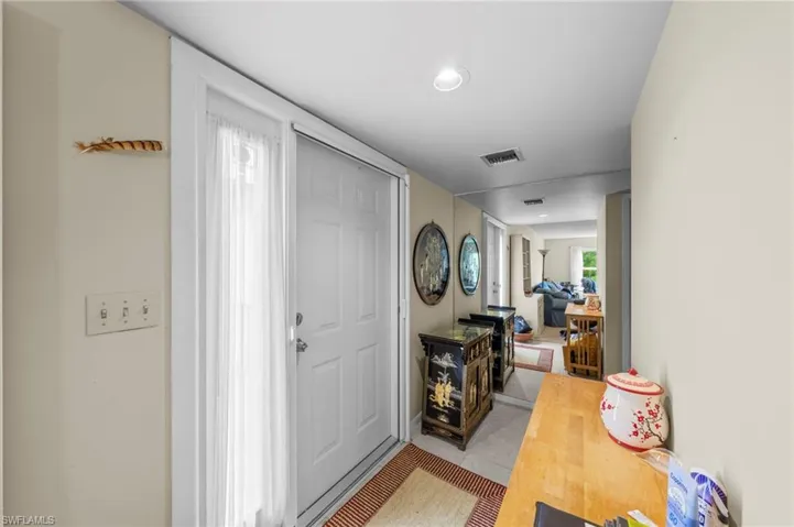 Tiled foyer entrance featuring recessed lighting