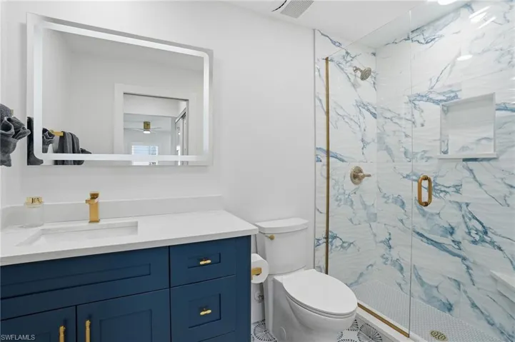 Full bathroom with vanity and a marble finish shower - Virtually Edited Image