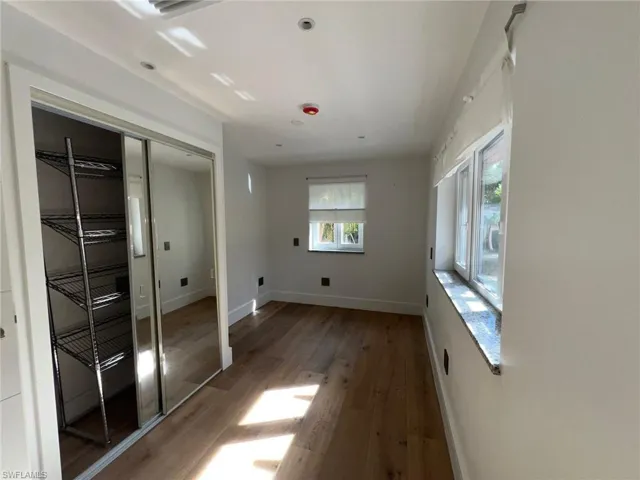 Unfurnished bedroom featuring a closet and light wood-type flooring