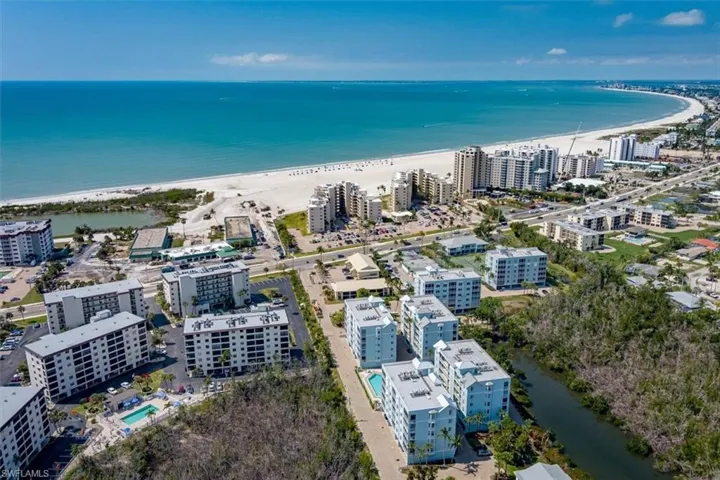 Drone / aerial view featuring a water view and a beach view
