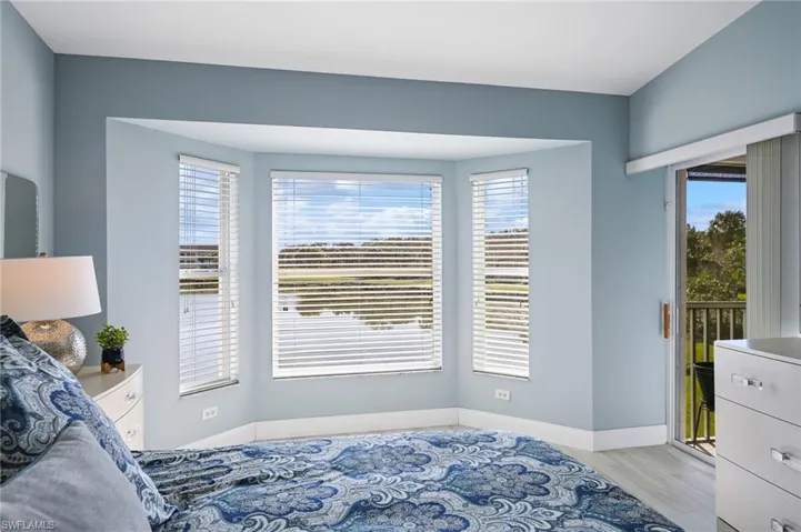 Primary Bedroom with view over lake & access to lanai
