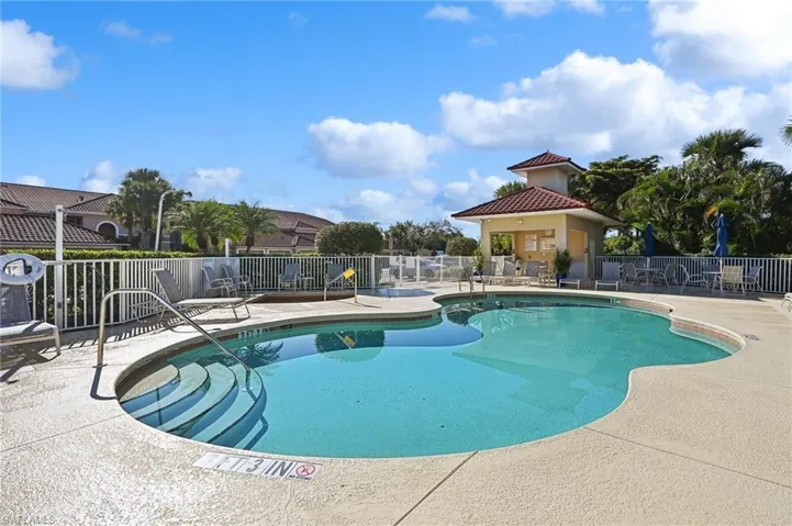 View of village swimming pool featuring a patio