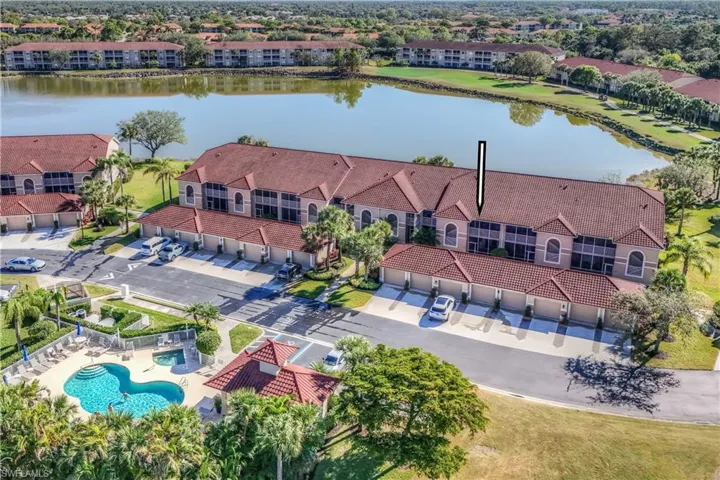 Bird's eye view featuring a water view & village pool