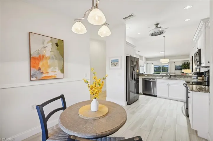 Eat-in Kitchen with light hardwood / wood-style flooring and sink