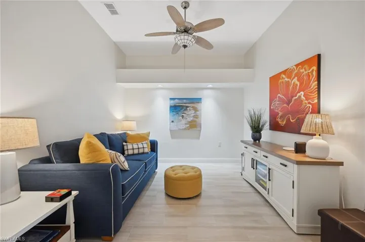 Living room featuring ceiling fan and light wood-type flooring