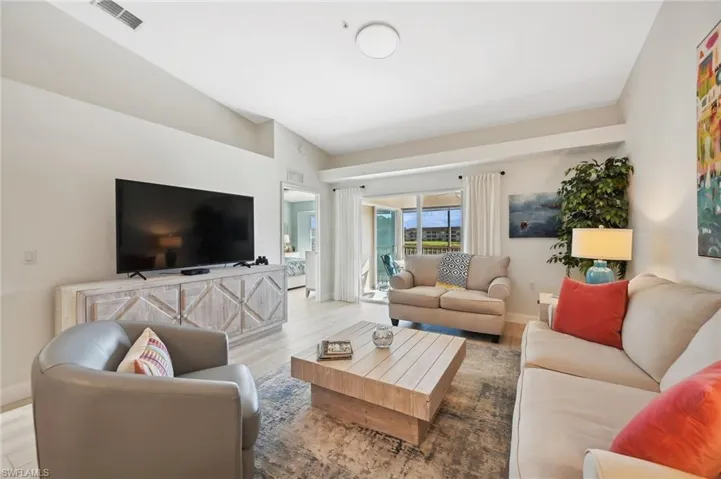 Living room featuring light hardwood / wood-style floors and vaulted ceiling