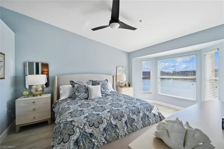 Primary Bedroom with ceiling fan and light hardwood / wood-style flooring