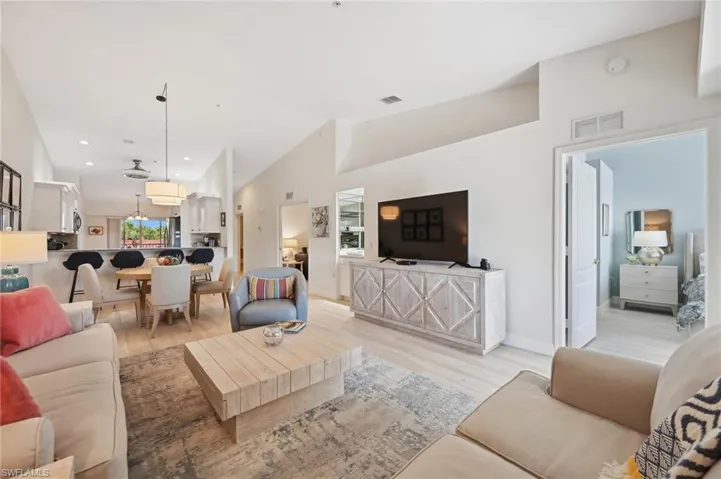 Living room featuring light hardwood / wood-style flooring and high vaulted ceiling
