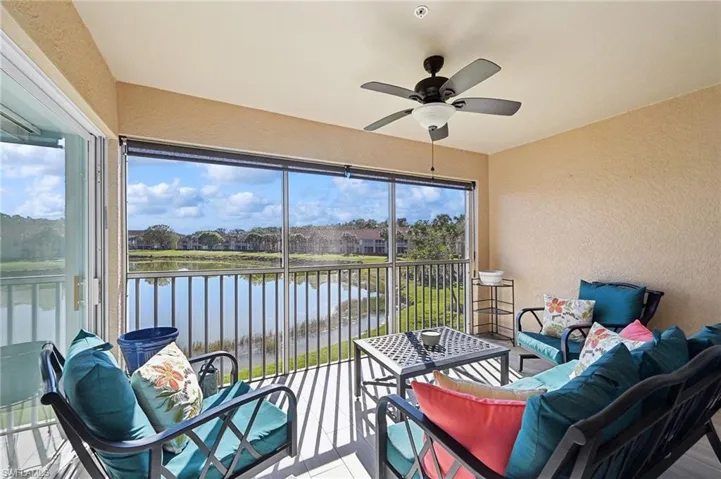 SE facing lanai featuring a water view, ceiling fan, and a healthy amount of sunlight
