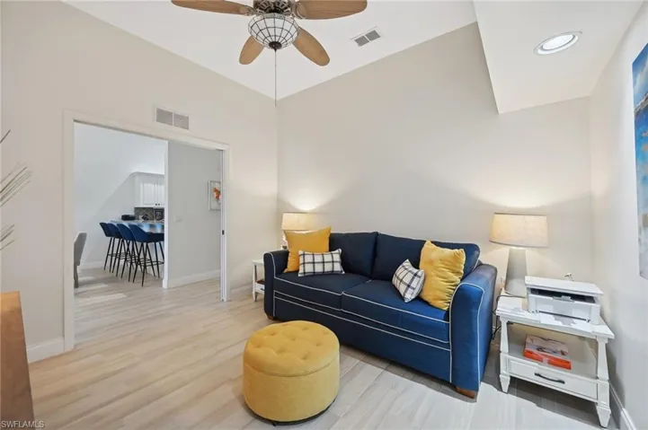 Living room with ceiling fan and light wood-type flooring