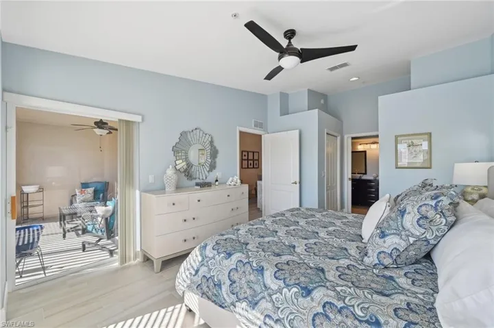 Bedroom with ceiling fan, a closet, and light hardwood / wood-style floors