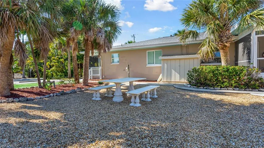 Back of property featuring outdoor dining area and stucco siding