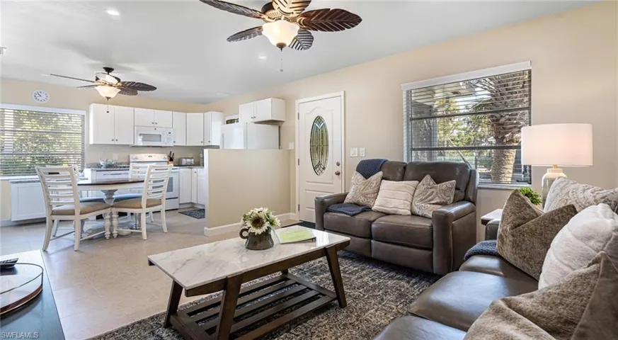 Living room featuring light tile patterned floors, a ceiling fan, and recessed lighting