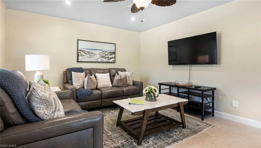 Living room featuring recessed lighting, a ceiling fan, and baseboards