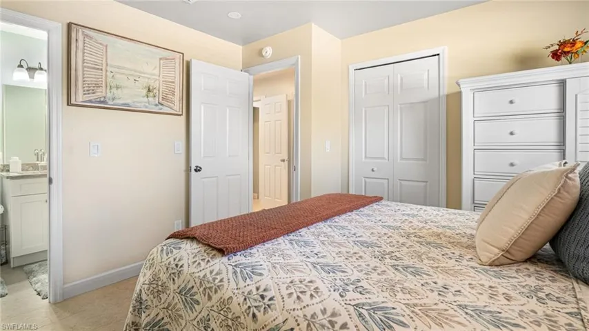 Bedroom with connected bathroom and baseboards