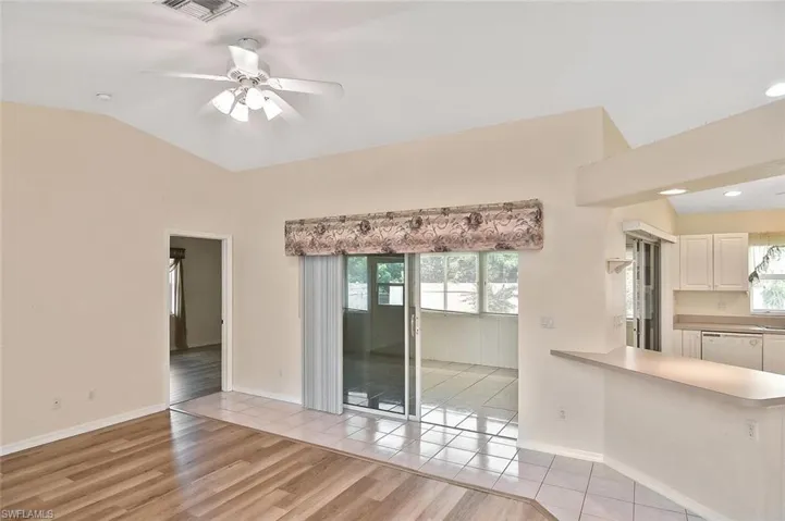 Unfurnished living room featuring light wood finished floors, healthy amount of natural light, ceiling fan, lofted ceiling, and recessed lighting