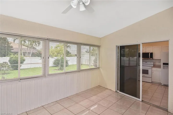 Unfurnished sunroom featuring vaulted ceiling