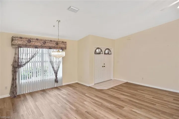 Unfurnished dining area featuring light wood-style floors and a chandelier