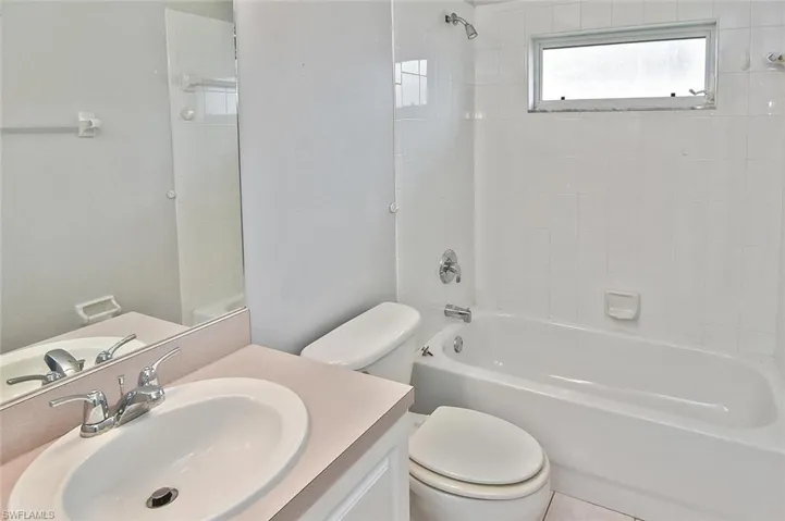 Full bath with bathing tub / shower combination, vanity, and tile patterned floors