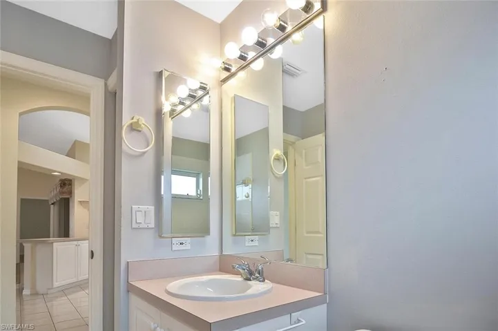 Half bathroom featuring vanity and tile patterned floors