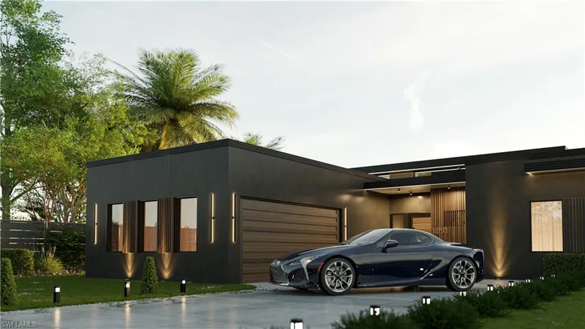 View of front of house with stucco siding, a garage, and a front yard