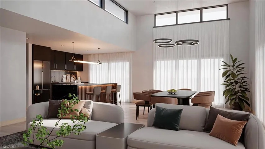 Living room with light wood-style floors, healthy amount of natural light, and a high ceiling