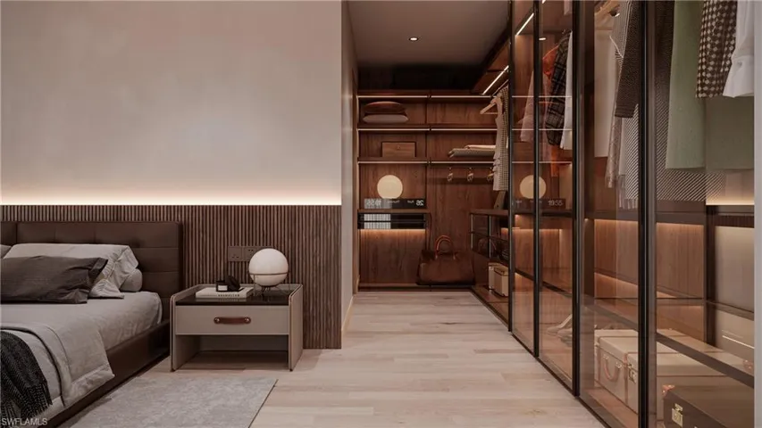 Bedroom featuring a wainscoted wall, light wood-style flooring, and wood walls