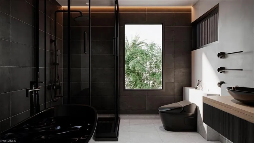 Bathroom featuring vanity, a stall shower, tile patterned flooring, and tile walls