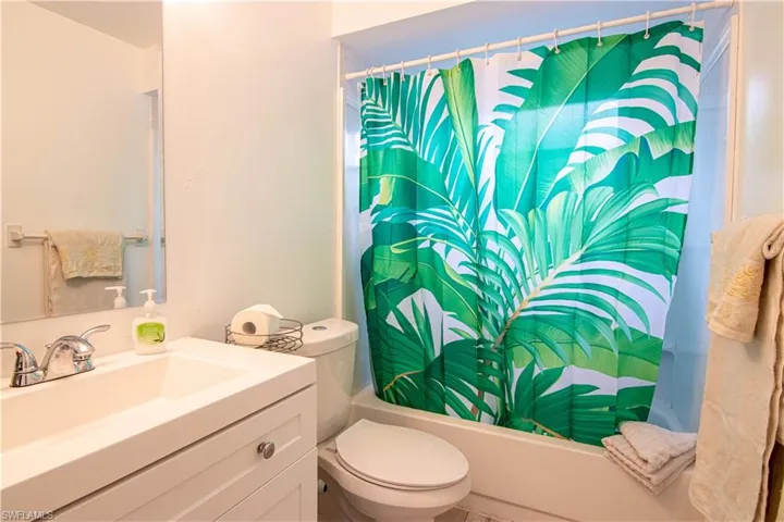 Full bath featuring vanity and shower / tub combo with curtain