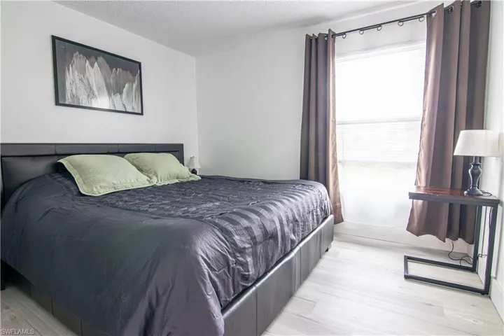 Bedroom featuring a textured ceiling and light wood-style floors