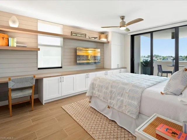 Bedroom featuring access to outside, wood finish floors, and ceiling fan